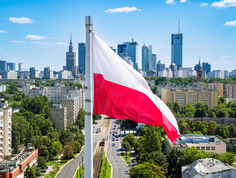 Polish,National,Flag,Against,Skyscrapers,In,Warsaw,City,Center,,Aerial