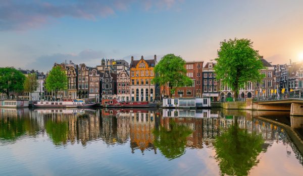 Downtown Amsterdam city skyline. Cityscape  in Netherlands at sunset